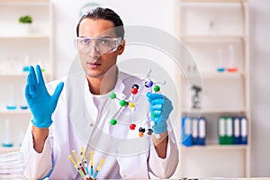 Young male nutrition expert testing food products in lab