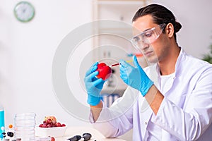 Young male nutrition expert testing food products in lab