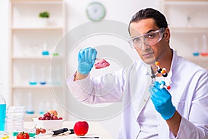 Young male nutrition expert testing food products in lab