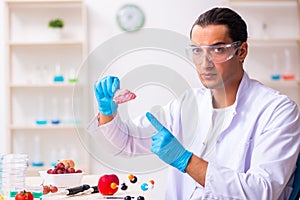 Young male nutrition expert testing food products in lab