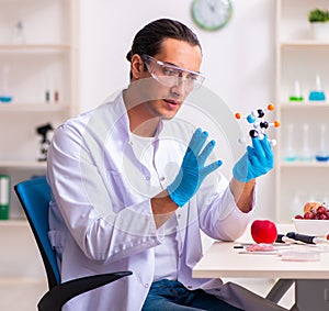 Young male nutrition expert testing food products in lab