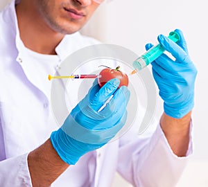 Young male nutrition expert testing food products in lab