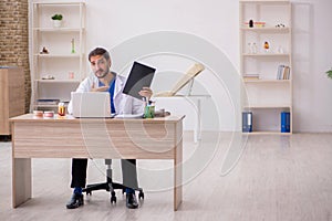 Young male odontologist working in the clinic photo