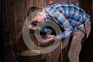 Young male opened a barrel and trying to solve a conundrum to ge