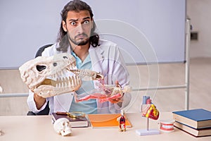 Young male paleontologist in front of the whiteboard