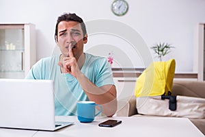 Young male parent looking after newborn at home