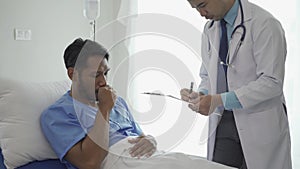 Young male patient having health check and consulting doctor in hospital, doctor's office