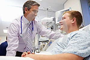 Young Male Patient Talking To Consultant In Emergency Room