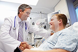 Young Male Patient Talking To Doctor In Emergency Room