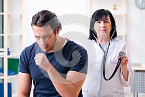 Young male patient visiting aged female doctor