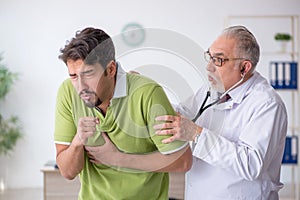 Young male patient visiting old male doctor