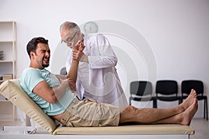 Young male patient visiting old male doctor