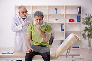 Young male patient visiting old male doctor