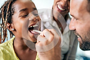 Young male pediatrician doctor examining child at office. Healthcare prevention exam people concept