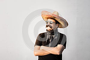 Young male person dressed up in traditional mexican sombrero, fa