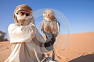 Young male pharaoh eagle owl during a desert falconry show in Dubai, UAE.