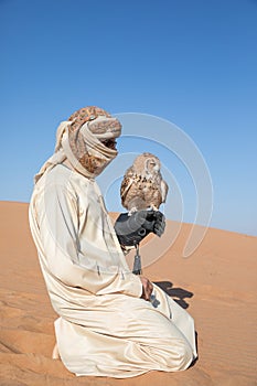 Young male pharaoh eagle owl during a desert falconry show in Dubai, UAE.