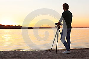 Young male photographer standing