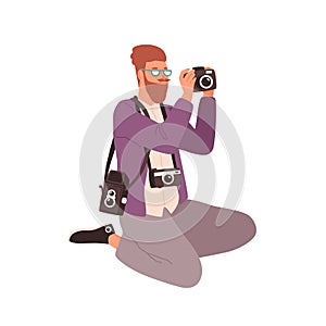 Young male photographer with TLR, digital and 35 mm cameras. Portrait of creative photojournalist with modern and retro