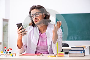 Young male physicist in the classroom