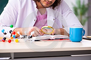 Young male physicist in the classroom