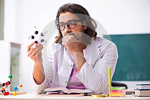 Young male physicist in the classroom