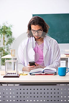 Young male physicist in the classroom