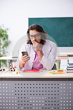 Young male physicist in the classroom