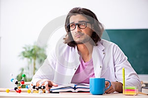 Young male physicist in the classroom