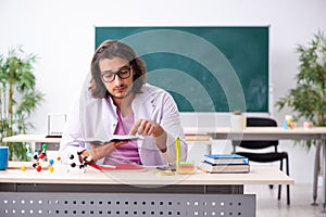 Young male physicist in the classroom