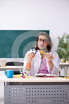 Young male physicist in the classroom