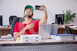 Young male pizza guy in industrial espionage concept