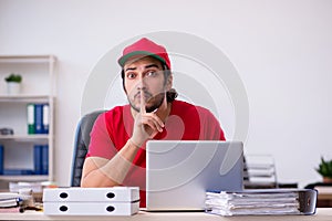 Young male pizza guy in industrial espionage concept