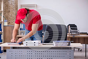 Young male pizza guy in industrial espionage concept