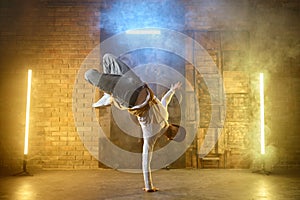 Young male professional dancer b-boying on studio stage