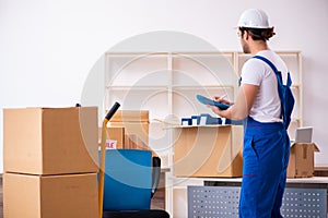 Young male professional mover doing home relocation