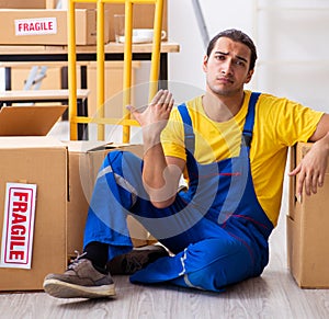 Young male professional mover doing home relocation