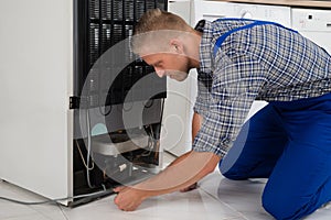 Repairman Making Refrigerator Appliance photo