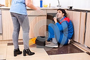 Young male repairman repairing tap