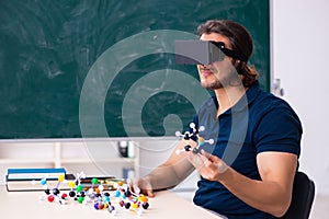 Young male scientist sitting in the classroom