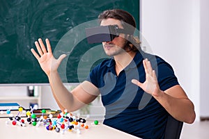 Young male scientist sitting in the classroom