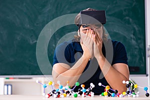 Young male scientist sitting in the classroom