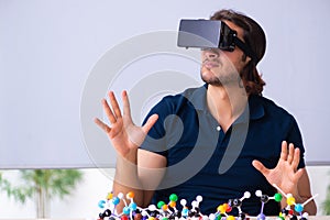 Young male scientist sitting in the classroom