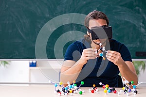 Young male scientist sitting in the classroom