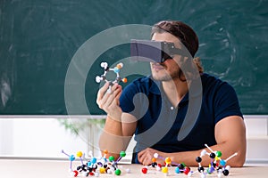 Young male scientist sitting in the classroom