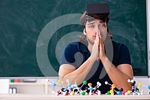 Young male scientist sitting in the classroom