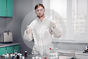 A young male scientist testing a Chemical in a science Laboratory. The scientistific analysis of chemicals for New
