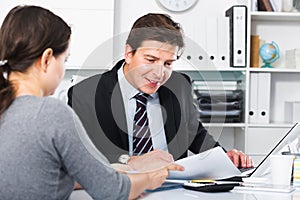 Young male speaking with female in the office