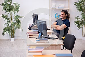 Young male student being tired during exam preparation