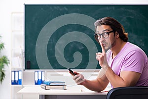 Young male student in the classroom